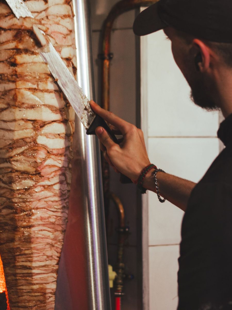Carving lamb from the kebab spit