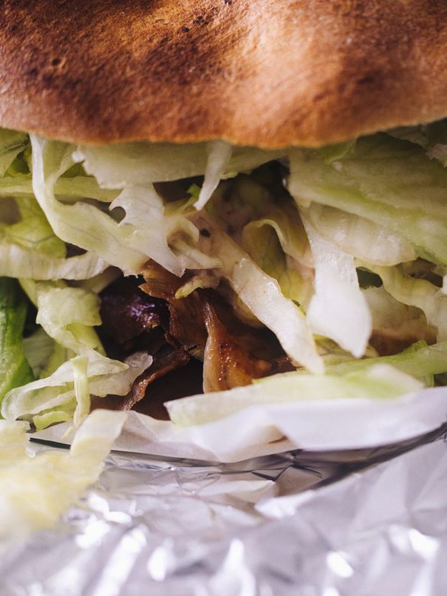 Kebab in warm pita bread loaded with fresh salad